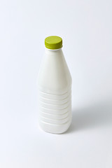 Image showing Mock-up dairy bottle from plastic on a light background.