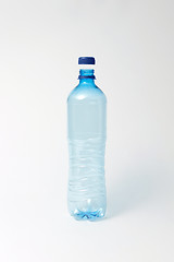 Image showing Blue transparent bottle for water on a light background. Mock up.