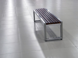 Image showing Bench with steel frame and wooden seat elements on the tile floor