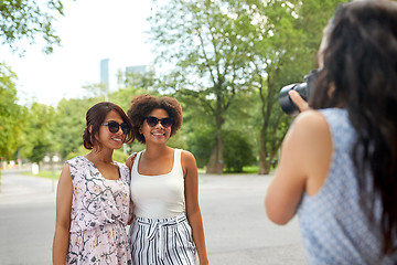 Image showing woman photographing her friends in summer park