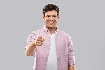 Image showing smiling man pointing fingers at you