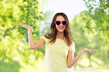 Image showing teenage girl in heart-shaped sunglasses