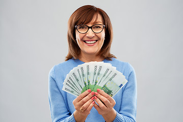 Image showing senior woman with hundreds of euro money banknotes