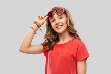 Image showing happy teenage girl in red heart shaped sunglasses