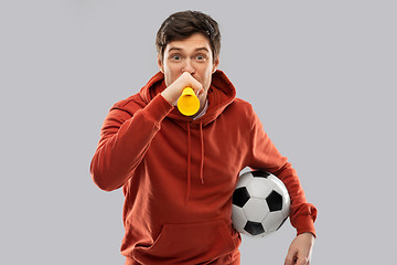 Image showing football fan with soccer ball blowing horn