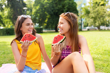 Image showing teenage girls eating watermelon at picnic in park