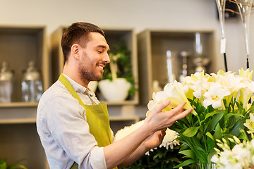 Image showing florist or seller with white lilies at flower shop