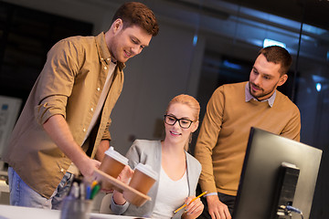 Image showing business team with coffee working at night office