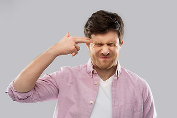 Image showing man making headshot by finger gun gesture