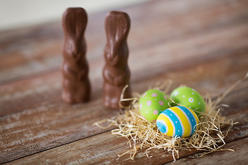 Image showing easter eggs in straw nest and chocolate bunnies