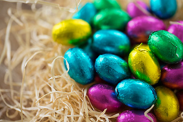 Image showing close up of chocolate easter eggs in straw nest