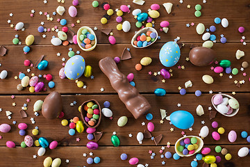 Image showing chocolate eggs, easter bunny and candies on wood