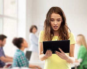 Image showing astonished student girl with tablet pc at school