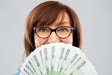 Image showing senior woman with hundreds of euro money banknotes