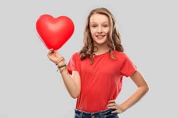 Image showing smiling teenage girl with red heart shaped balloon