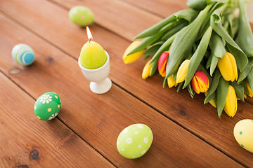 Image showing candle in shape of easter egg and tulip flowers