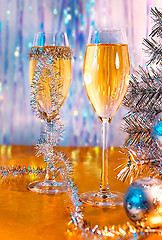 Image showing Glasses with wine, tinsel, Christmas tree and toys