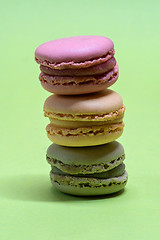 Image showing Macro shot of stack of macarons over green mint background