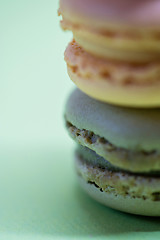 Image showing Macro shot of stack of macarons over green mint background