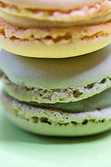 Image showing Macro shot of stack of macarons over green mint background