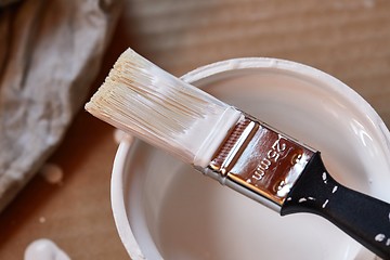 Image showing Paint brush on a can of white wall paint