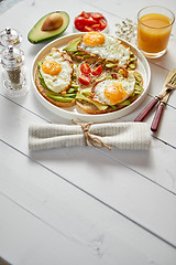 Image showing Delicious healthy breakfast with sliced avocado sandwiches with fried egg