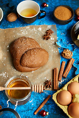 Image showing Gingerbread dough placed among various ingredients. Christmas baking concept