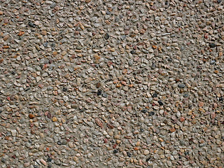 Image showing Concrete wall with sandy shapeless stones inlaid into it