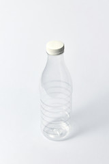 Image showing Transparent empty bottle for liquid on a light background. Mock up.