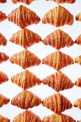 Image showing Rhombus french croissants pattern on a light background.