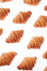 Image showing Food pattern with french homemade croissants on a white background.