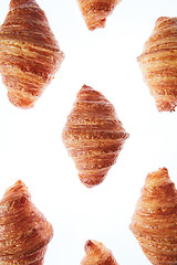 Image showing Freshly baked homemade croissants on a white background.