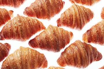 Image showing Close up homemade french croissants pattern on a white background.