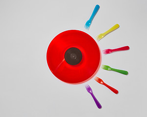 Image showing Colorful plastic forks around red vinyl record on a light gray background.