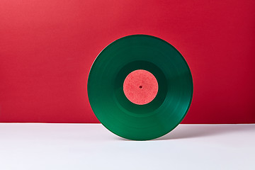 Image showing Vintage green vinyl record disk on a duotone background.