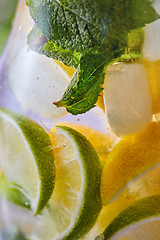 Image showing Summer drink glass of lemonade with lime and mint leaf.