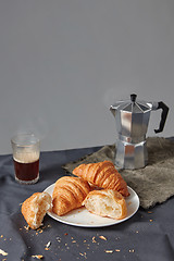 Image showing Continental breakfast with fresh croissant and natural coffee on a grey background.