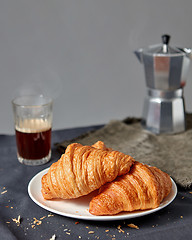 Image showing Morning breakfast with croissant and coffee on a gray background.