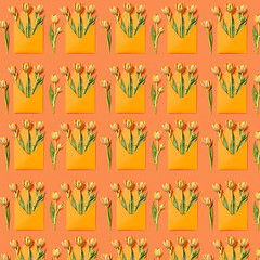 Image showing Decorative pattern with gift envelopes of tulips flowers on an orange.