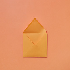 Image showing Handmade blank mock-up envelope on a peach color background.