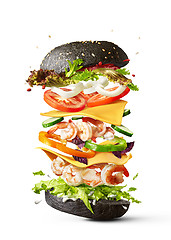 Image showing Flying burger with shrimp and fresh vegetables on a white backgr