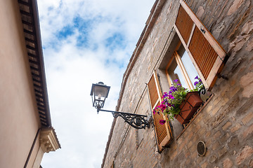 Image showing house in Italy with petunia flowers on the window