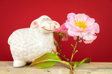 Image showing ceramics sheep figure with cherry blossom