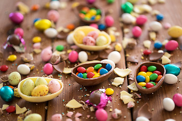 Image showing chocolate eggs and candy drops on wooden table