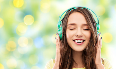 Image showing happy young woman or teenage girl with headphones