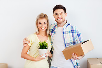 Image showing couple with box and flower moving to new home
