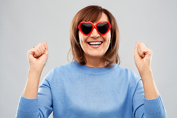 Image showing smiling senior woman in heart-shaped sunglasses