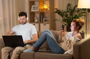 Image showing couple with laptop and smartphone resting at home