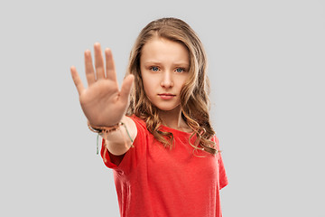 Image showing serious teenage girl showing stop gesture