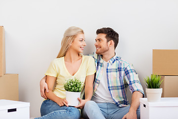 Image showing happy couple with boxes moving to new home